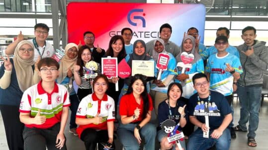 #TeamGreatech staff at a company event, Greatech-branded backdrop