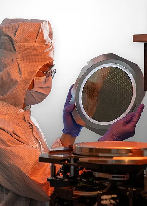Pentamaster cleanroom technician handling a semiconductor wafer